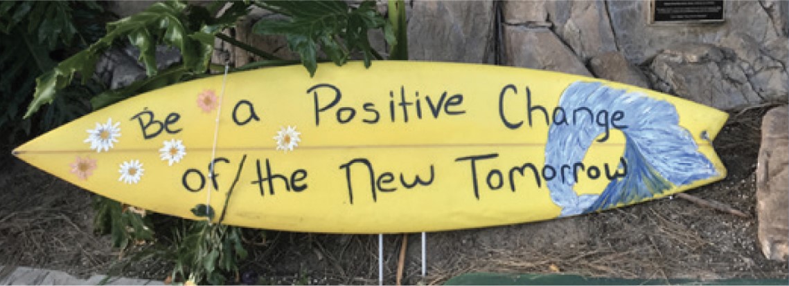 Surfboard with message: Be a Positive Change of the New Tomorrow
